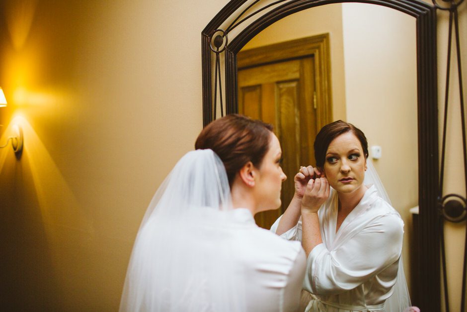 bride getting earrings on 