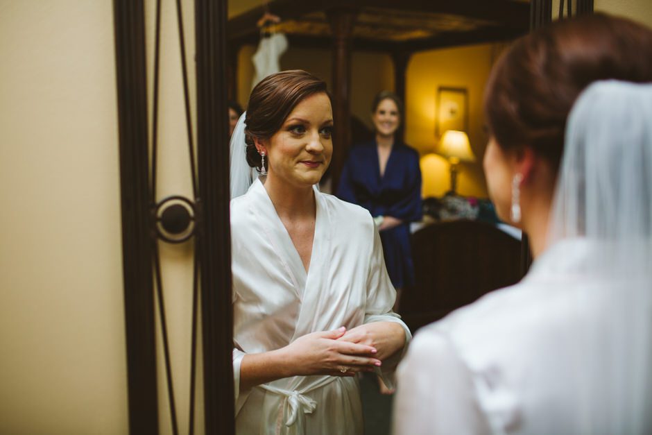friend looking at bride in mirror