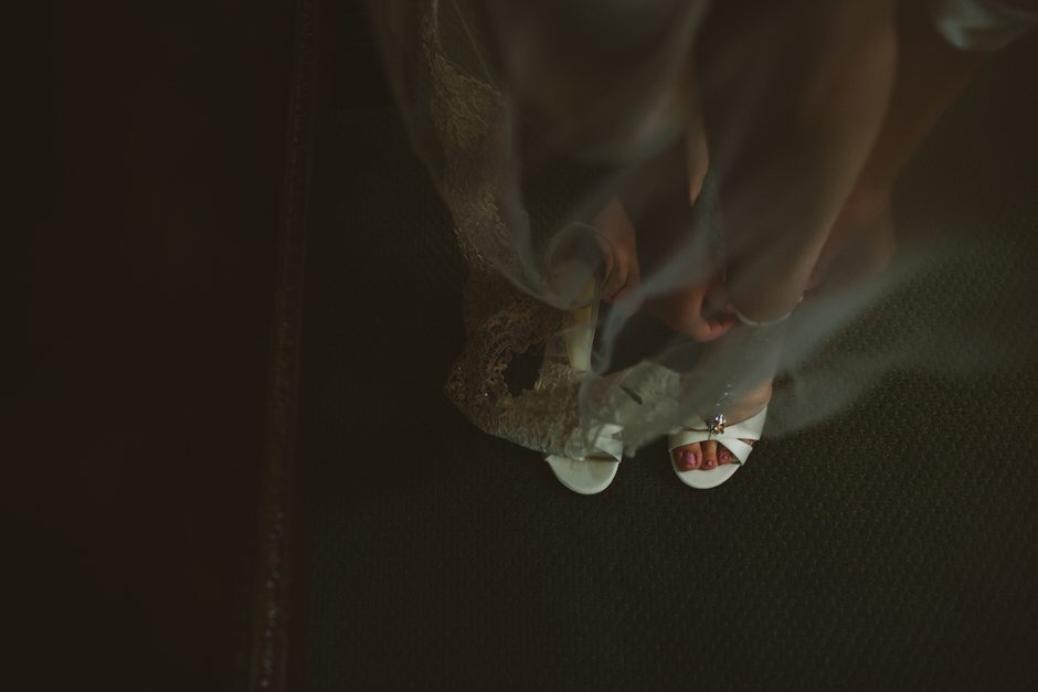 bride putting shoes on 