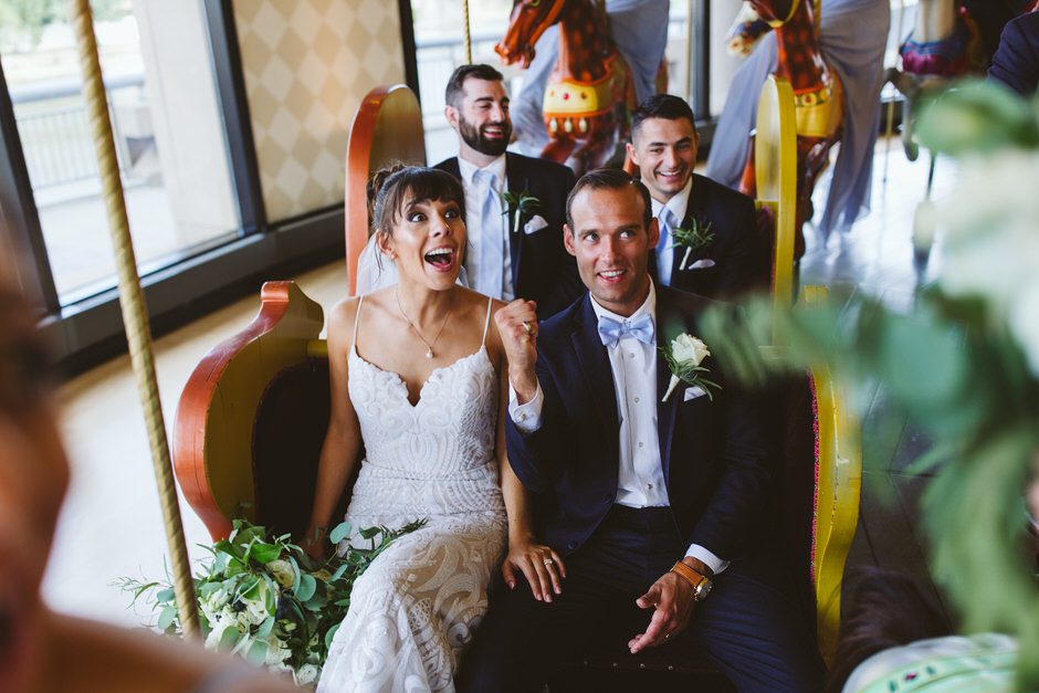 at Grand Rapids Public Art Museum couple smiling while riding the carousel 
