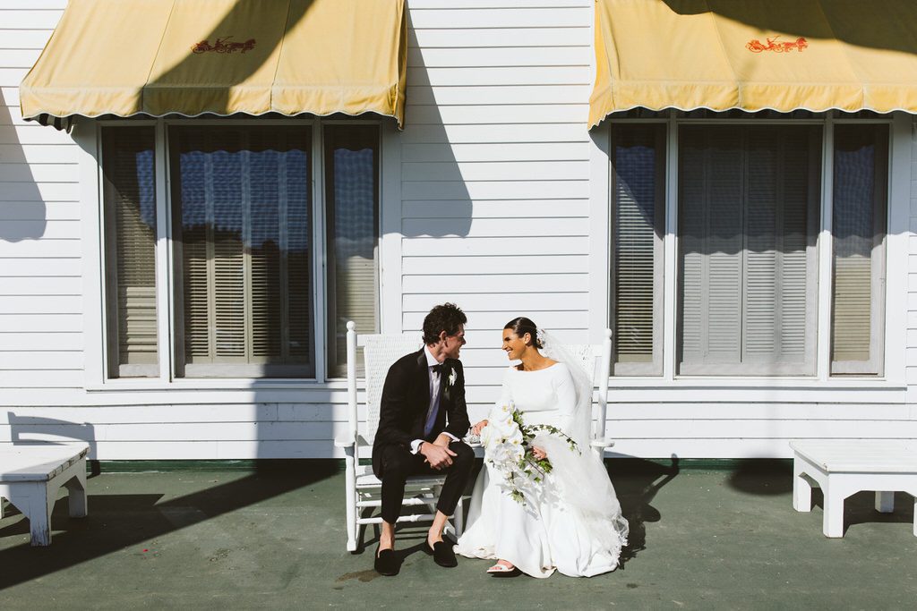 wedding couple on the rocking chairs on the porch of the Grand Hotel on Mackinac Island