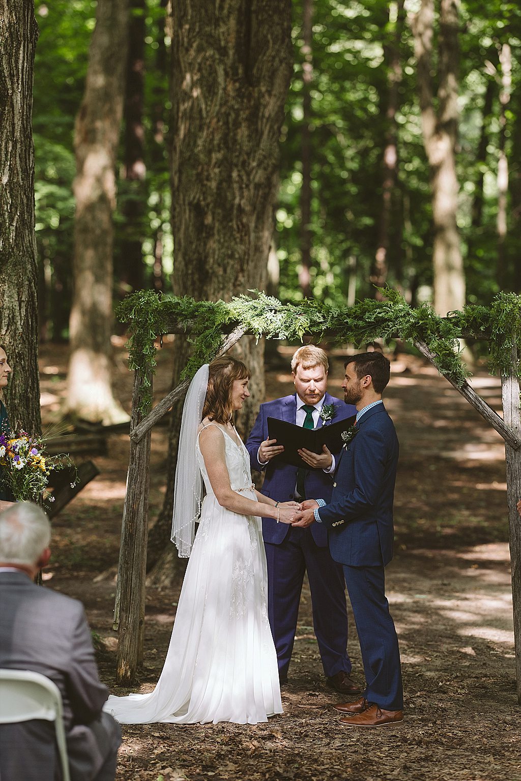 Outdoor ceremony under trees at Fenner Nature Center in Lansing, Michigan