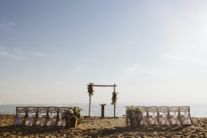 a beautiful setup of chairs and an arch on the beach in Grand Haven