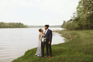 wedding couple by the lake at long lake outdoor center