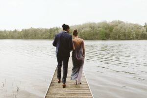 couple on the dock in the rain west michigan wedding