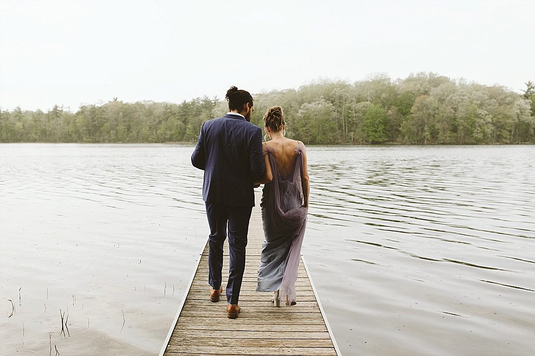 couple on the dock in the rain west michigan wedding