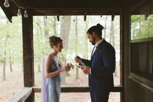 couple exchanging private vows under awning at long lake outdoor center